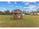Small shed with a porch in a grassy yard at 5105 Bannock Cir, North Port, FL 34288