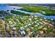Aerial view of a home near a waterway, surrounded by dense tropical vegetation at 5345 Siesta Ct, Sarasota, FL 34242