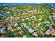 Aerial view of a single-Gathering home nestled in a lush, residential neighborhood at 5345 Siesta Ct, Sarasota, FL 34242