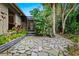 Flagstone patio, tropical landscaping, screened porch at 5345 Siesta Ct, Sarasota, FL 34242