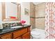 Clean bathroom with granite vanity, tub shower combo, and updated fixtures at 5345 Siesta Ct, Sarasota, FL 34242
