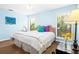 King bed in a light blue bedroom with hardwood floors at 5345 Siesta Ct, Sarasota, FL 34242