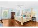 Main bedroom with hardwood floors and a ceiling fan at 5345 Siesta Ct, Sarasota, FL 34242