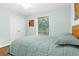 Serene bedroom with a full bed, hardwood floors, and garden view at 5345 Siesta Ct, Sarasota, FL 34242
