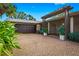 Home exterior with a dark garage door and pergola at 5345 Siesta Ct, Sarasota, FL 34242
