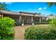 Home exterior showcasing a pergola and landscaping at 5345 Siesta Ct, Sarasota, FL 34242