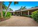 House exterior featuring a gravel driveway and lush landscaping at 5345 Siesta Ct, Sarasota, FL 34242