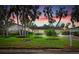 Beautiful home with lush landscaping and palm trees at sunset at 5345 Siesta Ct, Sarasota, FL 34242