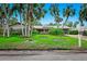 Single-Gathering home with lush landscaping and palm trees at 5345 Siesta Ct, Sarasota, FL 34242