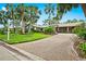 Single-Gathering home with a large driveway and mature landscaping at 5345 Siesta Ct, Sarasota, FL 34242