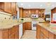 Modern kitchen with granite countertops and wood cabinets at 5345 Siesta Ct, Sarasota, FL 34242