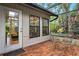 Brick patio with table and chairs, screened enclosure at 5345 Siesta Ct, Sarasota, FL 34242