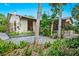 Stone patio with lush landscaping and access to the home and backyard at 5345 Siesta Ct, Sarasota, FL 34242