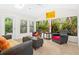 Sunroom with wicker furniture, tile floors and view to garden at 5345 Siesta Ct, Sarasota, FL 34242
