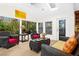 Relaxing sunroom featuring wicker furniture and large windows at 5345 Siesta Ct, Sarasota, FL 34242