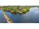 Aerial view displaying a dock amidst serene waters, showcasing the picturesque waterfront and lush vegetation at 5611 Key West Pl # 5611, Bradenton, FL 34203