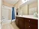 Full bath with tub, shower, and vanity with dark wood cabinets providing ample storage at 5611 Key West Pl # 5611, Bradenton, FL 34203