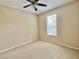 Neutral bedroom with light carpet, ceiling fan, and a window for natural light at 5611 Key West Pl # 5611, Bradenton, FL 34203