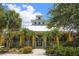 Beautiful clubhouse featuring a porch with palm trees and manicured landscaping at 5611 Key West Pl # 5611, Bradenton, FL 34203