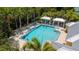 Inviting community pool area surrounded by lounge chairs, cabanas, and tropical landscaping at 5611 Key West Pl # 5611, Bradenton, FL 34203