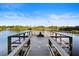 Scenic view of the community dock on the water, complete with benches and a flagpole at 5611 Key West Pl # 5611, Bradenton, FL 34203