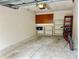 Garage area with shelving, storage, and a parked bicycle at 5611 Key West Pl # 5611, Bradenton, FL 34203