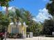 Gated entrance with a guardhouse, palm trees, and lush landscaping at 5611 Key West Pl # 5611, Bradenton, FL 34203