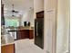 Open kitchen featuring stainless steel appliances, granite countertops, and cherry wood cabinetry at 5611 Key West Pl # 5611, Bradenton, FL 34203