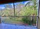 Screened patio with outdoor view showing tree coverage and blue sky above at 5611 Key West Pl # 5611, Bradenton, FL 34203