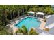 Aerial view of community pool with lounge chairs and covered seating areas at 5611 Key West Pl # 5611, Bradenton, FL 34203