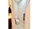 Small half-bath with toilet and towel bar, ideal for guests at 5611 Key West Pl # 5611, Bradenton, FL 34203