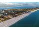 Breathtaking aerial view of coastal real estate showing the beach, ocean and nearby homes at 5965 Gulf Of Mexico Dr, Longboat Key, FL 34228