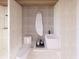 Bright bathroom featuring modern fixtures, unique mirror, and a stylish floating sink at 5965 Gulf Of Mexico Dr, Longboat Key, FL 34228