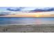Calm beach waters at sunset, offering a serene and picturesque coastal view at 5965 Gulf Of Mexico Dr, Longboat Key, FL 34228