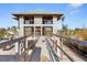 Exterior view of home under construction, showing the block construction and a long ramp leading to the entrance at 5965 Gulf Of Mexico Dr, Longboat Key, FL 34228
