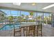 Enclosed pool area with patio furniture and water view at 611 Ranger Ln, Longboat Key, FL 34228