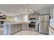 Modern kitchen with stainless steel appliances, breakfast bar, and ample counter space at 6824 Haawi Ct, North Port, FL 34287