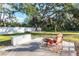 Spacious backyard with a fire pit, seating, and white fence at 7005 57Th E Ter, Palmetto, FL 34221