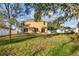 Backyard with green grass, patio area, and mature trees at 7005 57Th E Ter, Palmetto, FL 34221