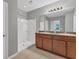 Modern bathroom featuring double vanities, shower, and neutral-toned tile at 7005 57Th E Ter, Palmetto, FL 34221