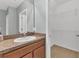 Bathroom vanity area with single sink, granite-like countertop, and walk-in closet at 7005 57Th E Ter, Palmetto, FL 34221