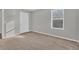 Empty bedroom with gray walls, plush carpet, and a closed door at 7005 57Th E Ter, Palmetto, FL 34221