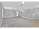 Large, carpeted bonus room with gray walls, ceiling fan, and plenty of space at 7005 57Th E Ter, Palmetto, FL 34221