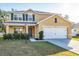 Front exterior of a two-story home with a driveway, attached garage, and landscaping at 7005 57Th E Ter, Palmetto, FL 34221