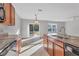 Kitchen with double sink, wood cabinets, and view of the backyard at 7005 57Th E Ter, Palmetto, FL 34221