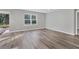 Spacious living room with wood-look flooring and large window at 7005 57Th E Ter, Palmetto, FL 34221