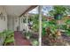 Relaxing covered front porch surrounded by vibrant potted plants at 7030 Bright Creek Dr # 51, Sarasota, FL 34231