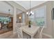 Cozy breakfast nook with white table and chairs near kitchen at 734 Foggy Morn Ln, Bradenton, FL 34212