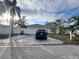 Front view of the house with driveway and landscaping at 7660 39Th Street E Cir, Sarasota, FL 34243