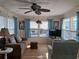 Bright living room with brown couches, light wood floors, and a TV at 80 3Rd Ave, Venice, FL 34285